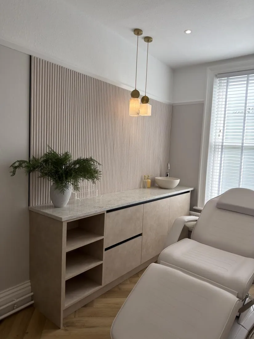 Part-time treatment room with fluted panelling, marble worktop and brass pendant lights