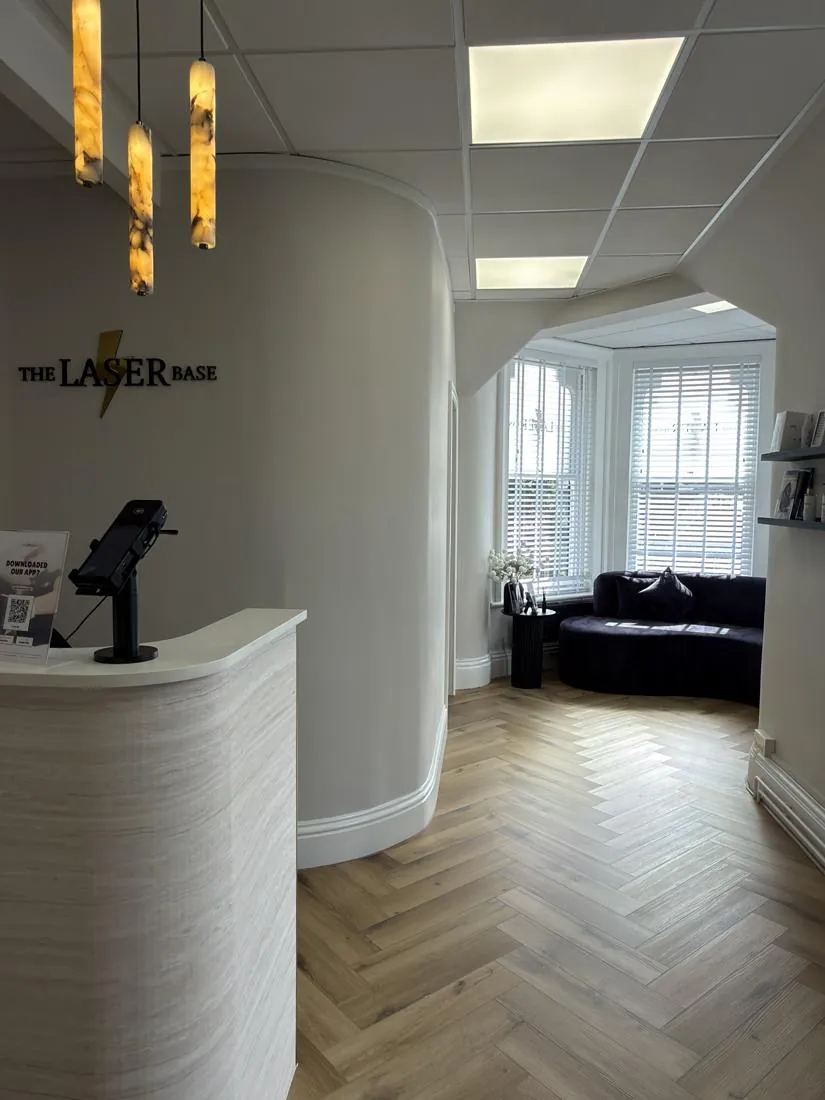 Reception desk with The Laser Base signage